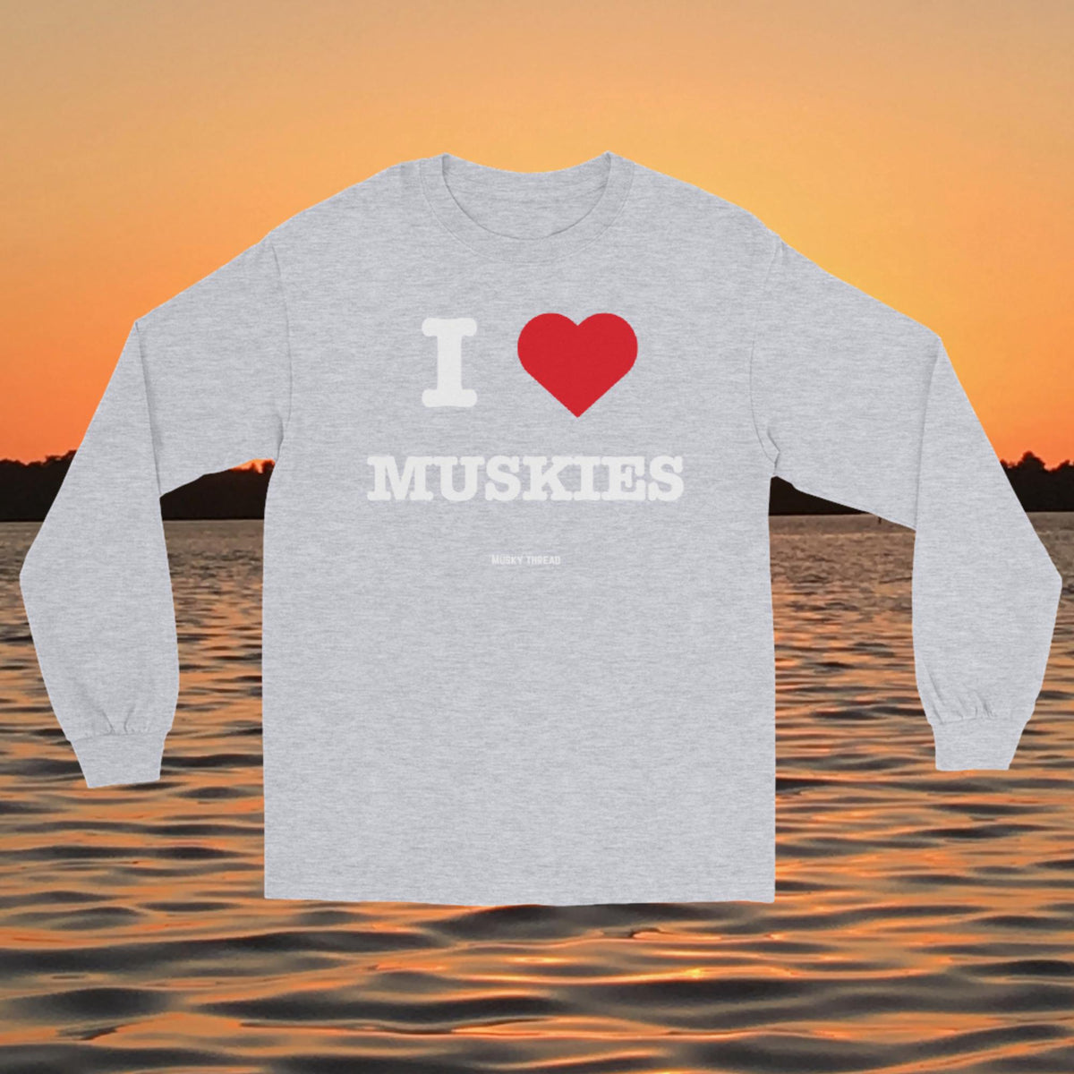 I Love Muskies long sleeve shirt with red heart design over a lake sunset