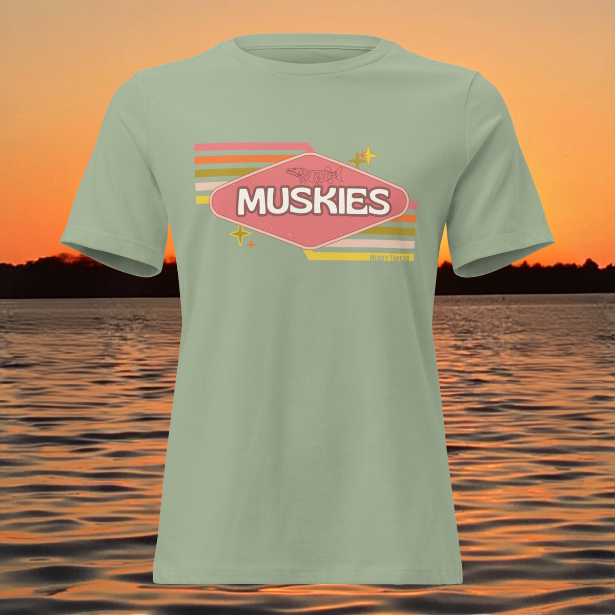Retro Muskie Sign t-shirt featuring vintage pink and yellow badge graphic with musky fish illustration, lake sunset background