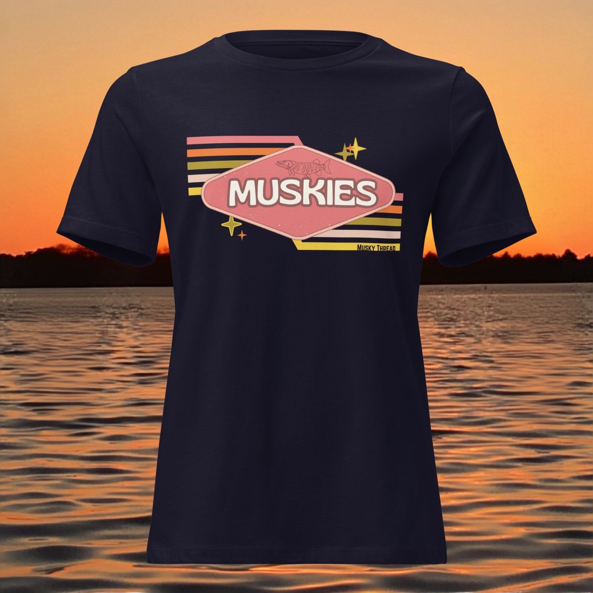 Retro Muskie Sign t-shirt featuring vintage pink and yellow badge graphic with musky fish illustration, lake sunset background
