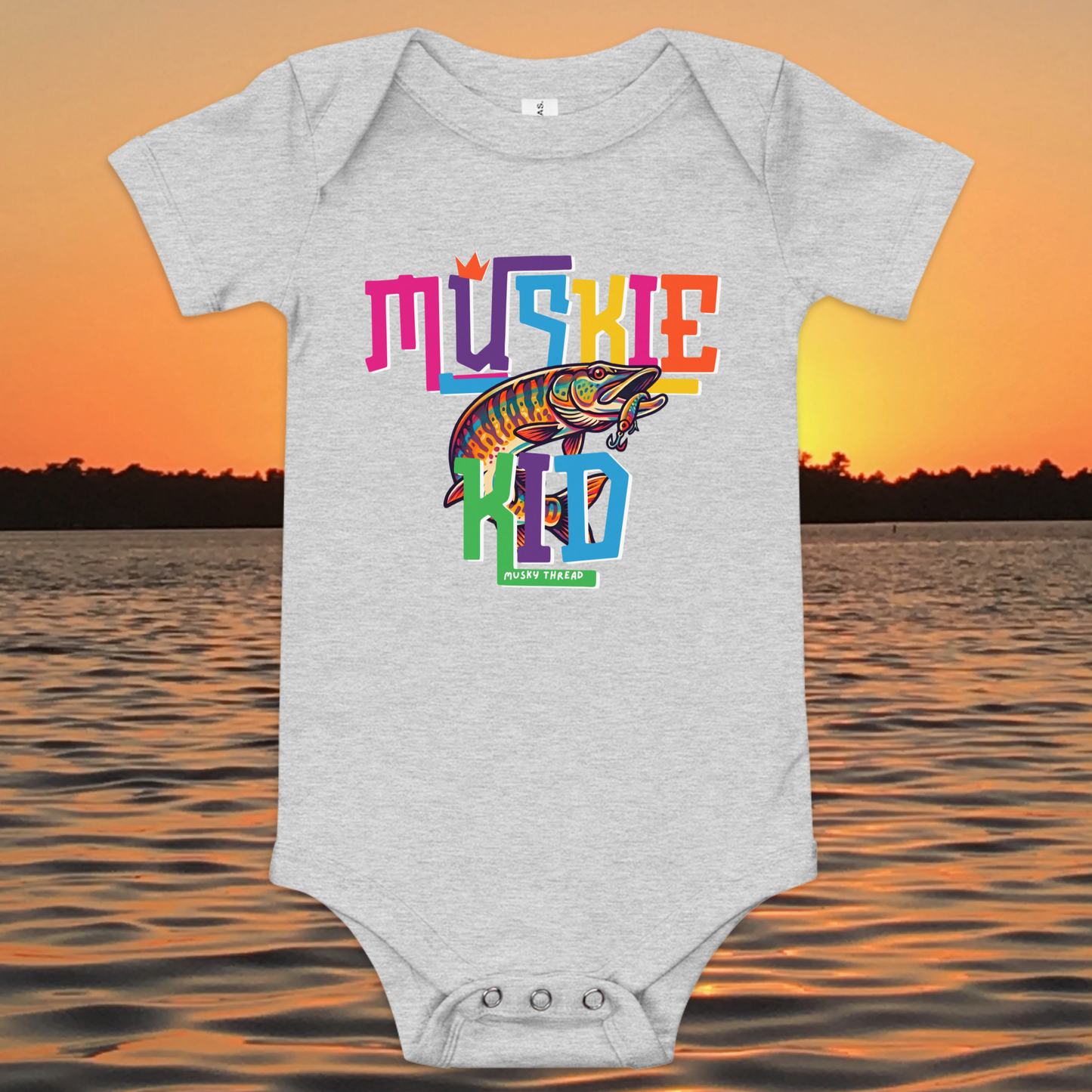 Baby short-sleeve onesie with colorful Muskie Kid street-design graphic featuring a jumping musky fish