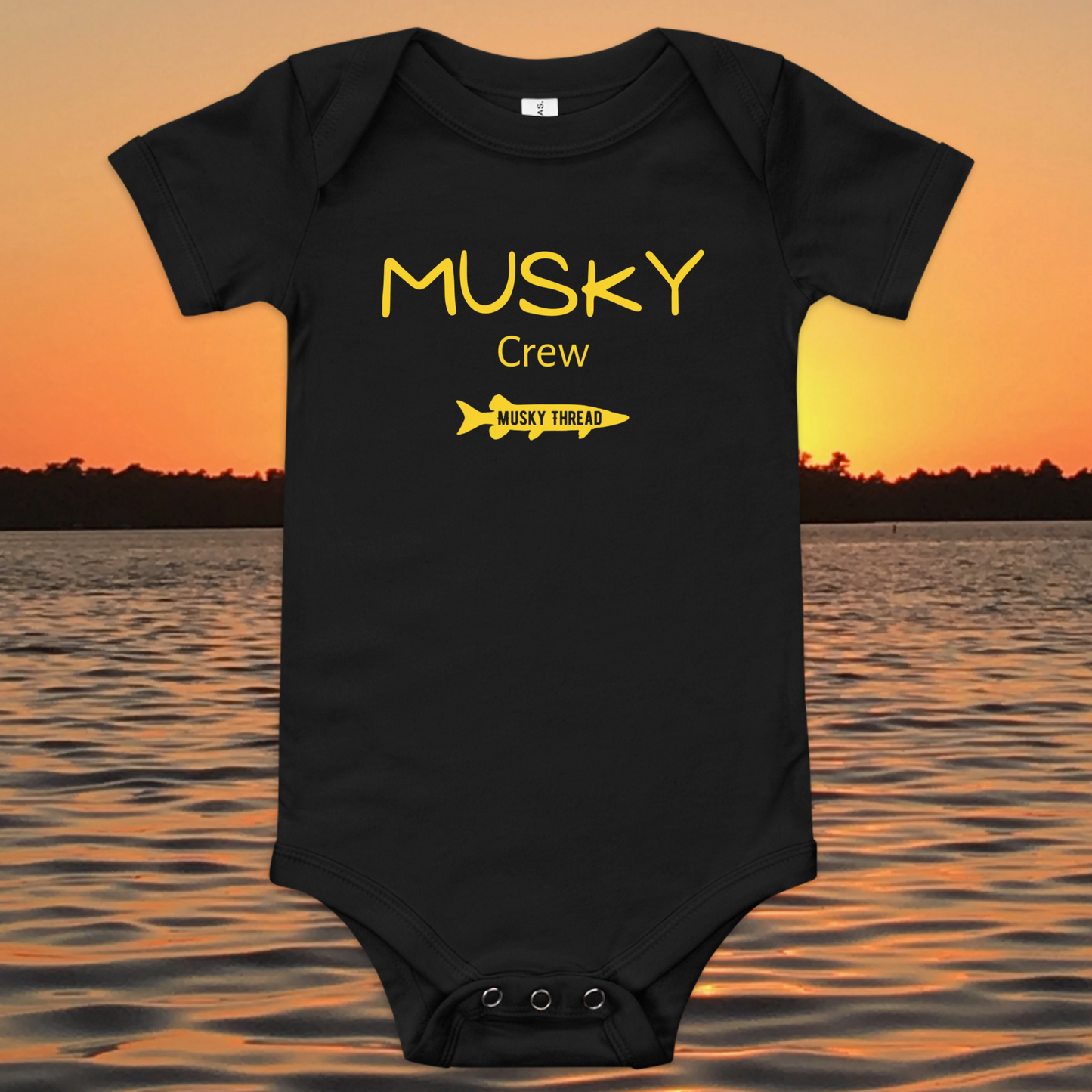 baby onesie with musky crew fishing design yellow text musky thread logo sunset lake background