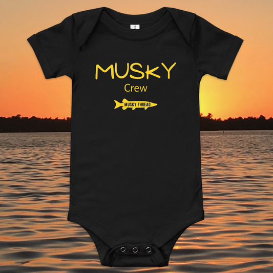 baby onesie with musky crew fishing design yellow text musky thread logo sunset lake background