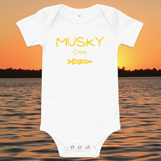 baby onesie with musky crew fishing design yellow text musky thread logo sunset lake background