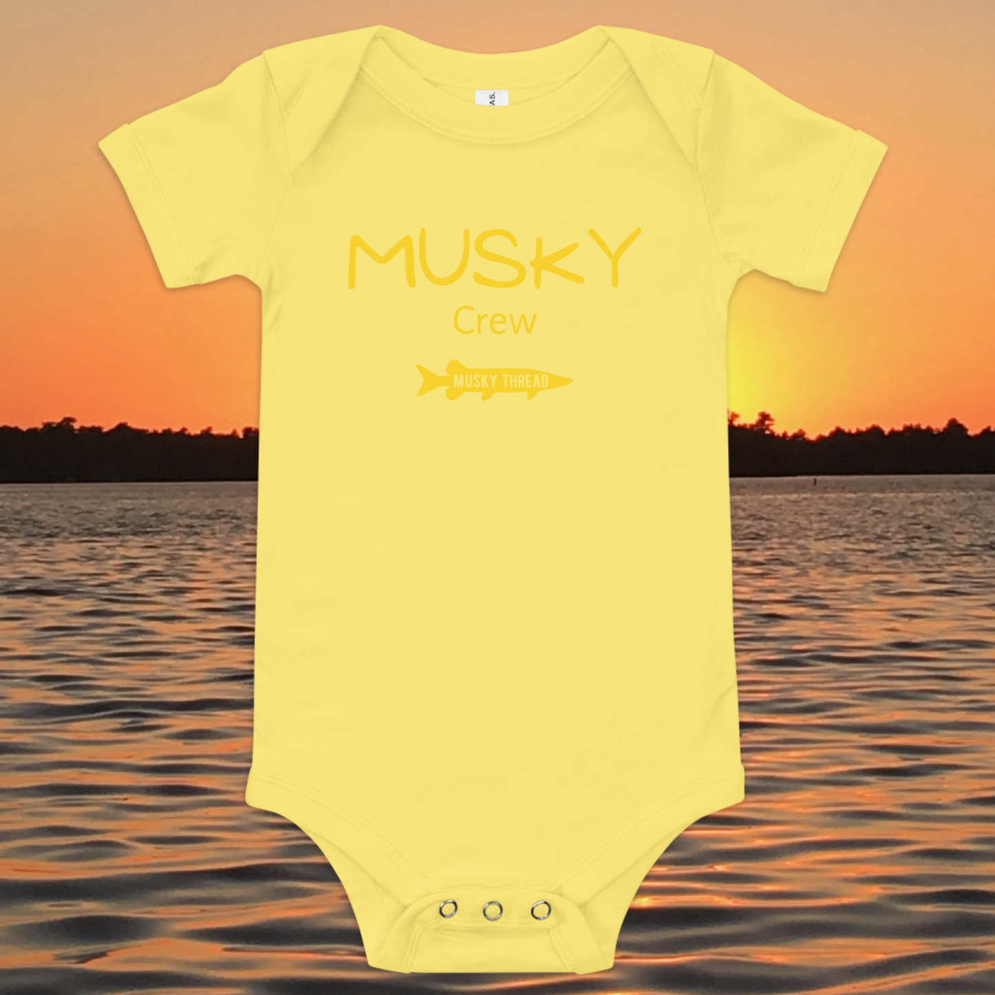 baby onesie with musky crew fishing design yellow text musky thread logo sunset lake background