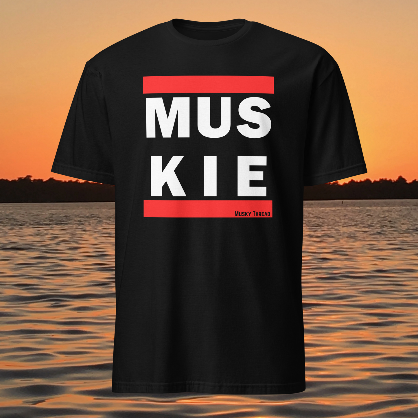 Muskie fishing t-shirt front view with bold red and white lettering
Close-up of MUSKIE text design on black t-shirt
Model wearing black muskie fishing t-shirt outdoors