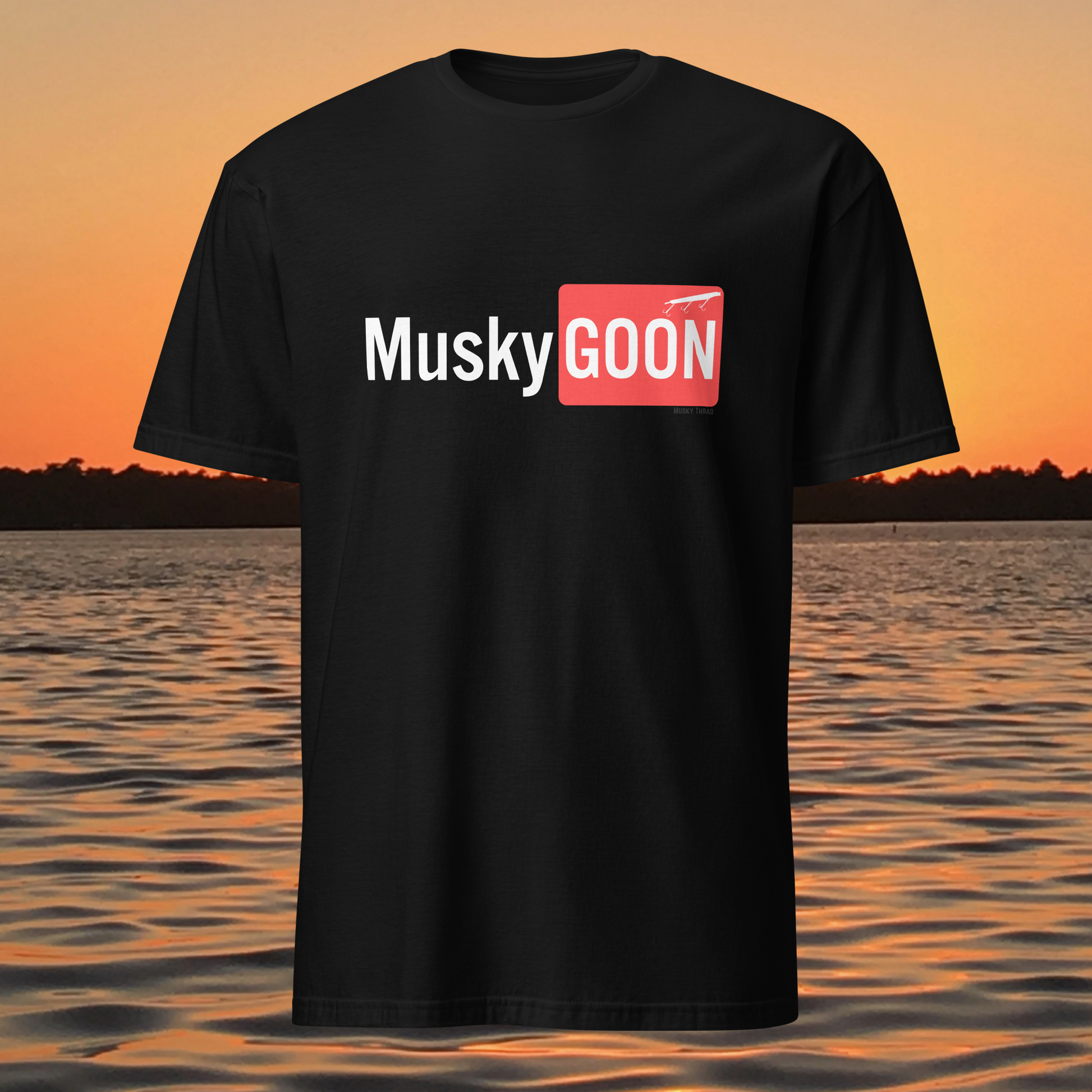 unisex t-shirt with "Musky GOON" text logo, lake sunset background