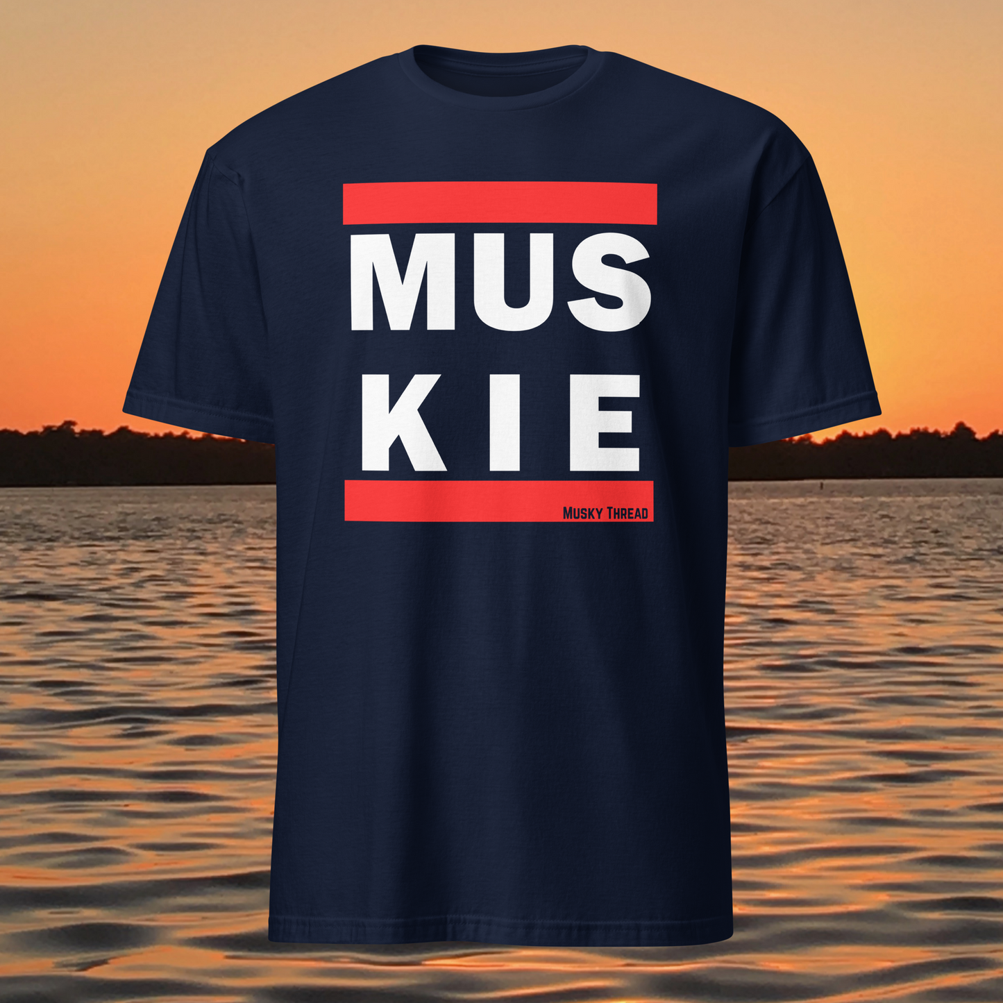 Muskie fishing t-shirt front view with bold red and white lettering
Close-up of MUSKIE text design on black t-shirt
Model wearing black muskie fishing t-shirt outdoors