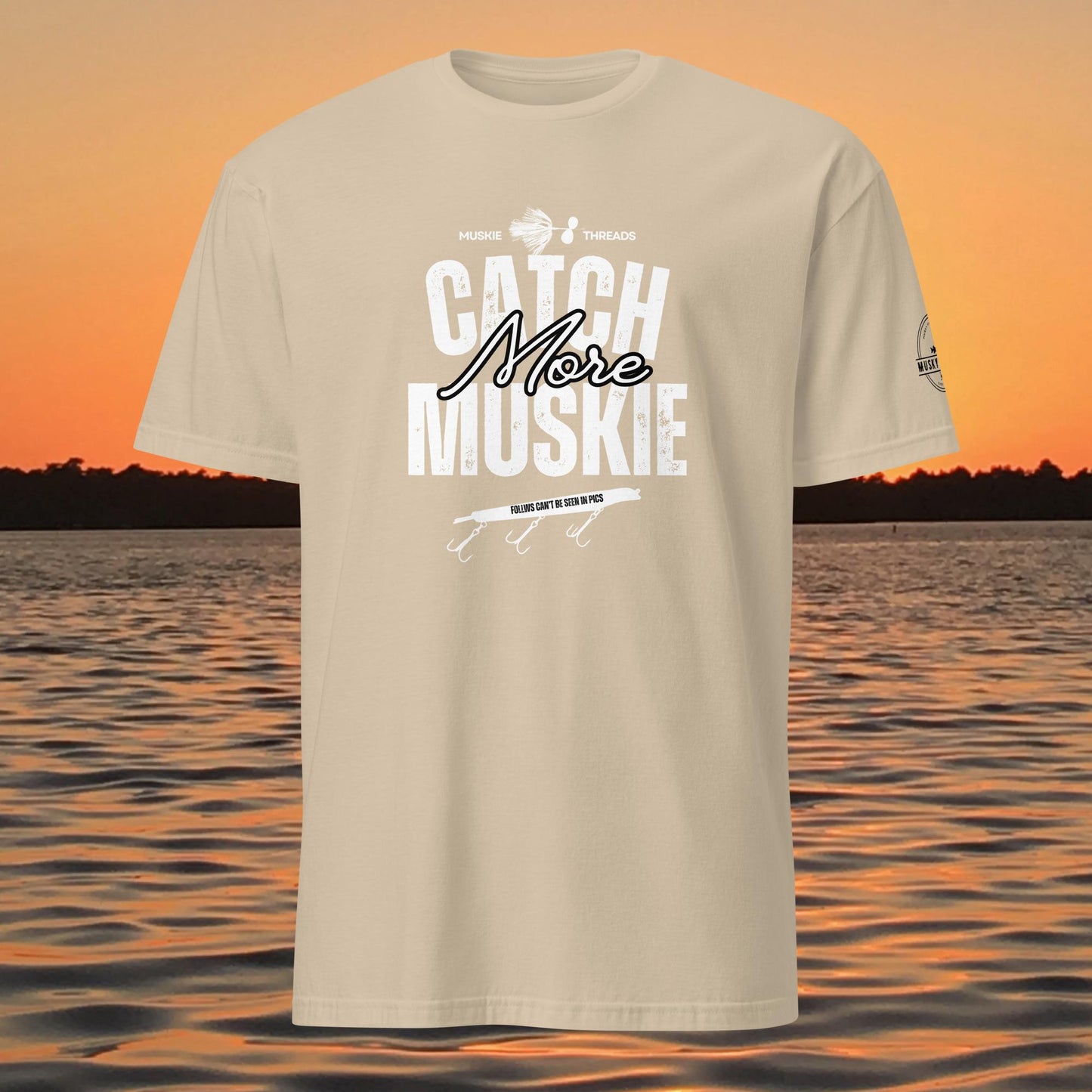 Catch More Muskie t-shirt with fishing lure graphic and “follows can’t be seen in pics” text on tan shirt
