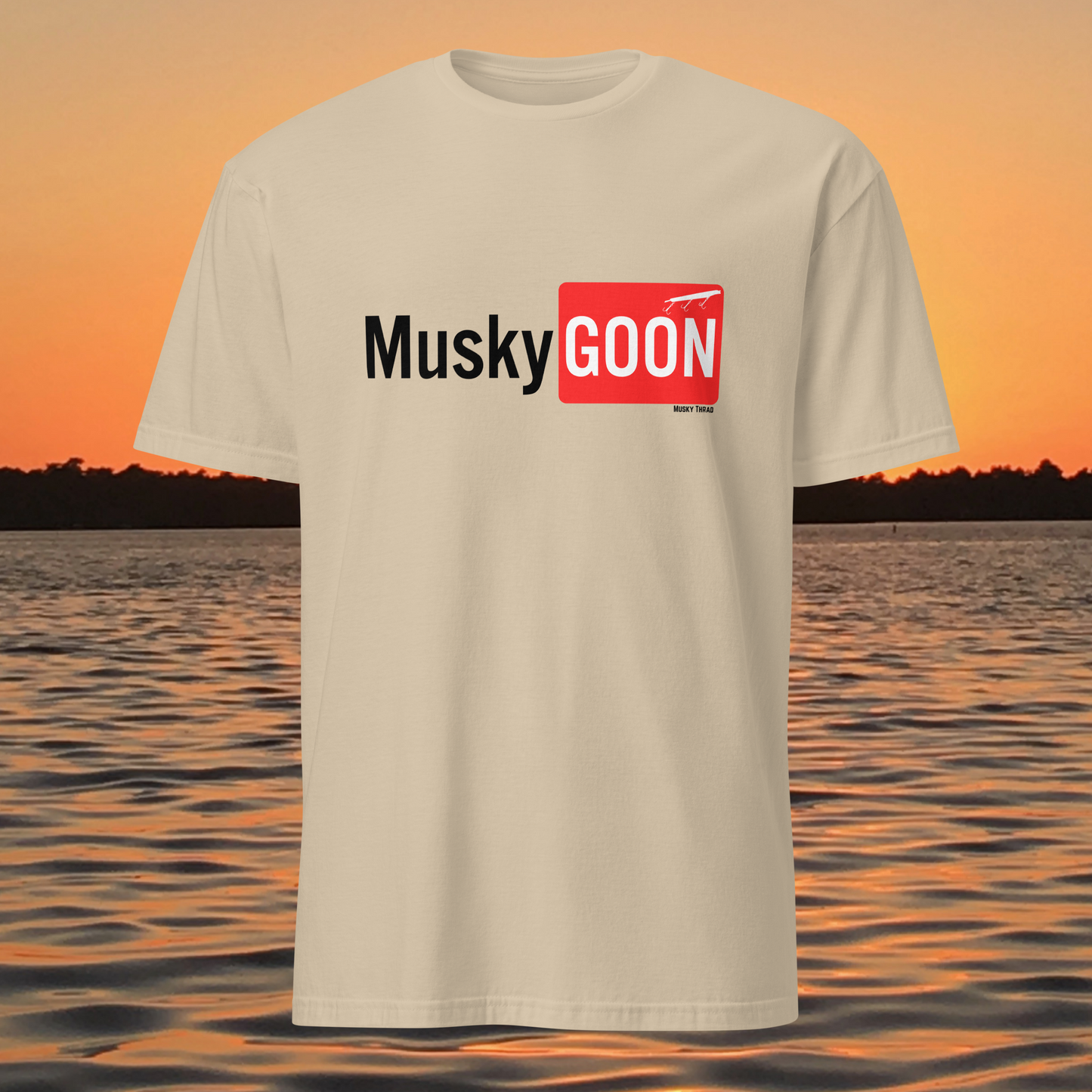 unisex t-shirt with "Musky GOON" text logo, lake sunset background