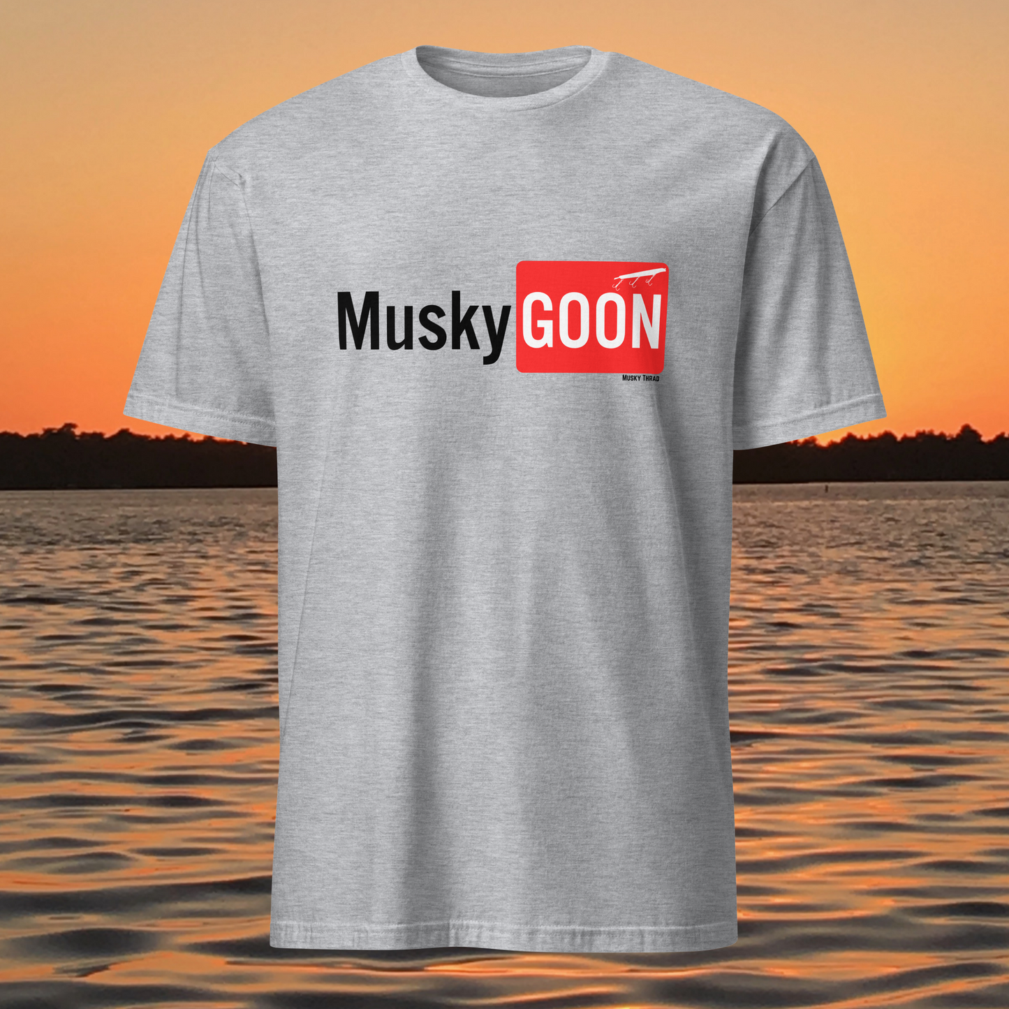 unisex t-shirt with "Musky GOON" text logo, lake sunset background