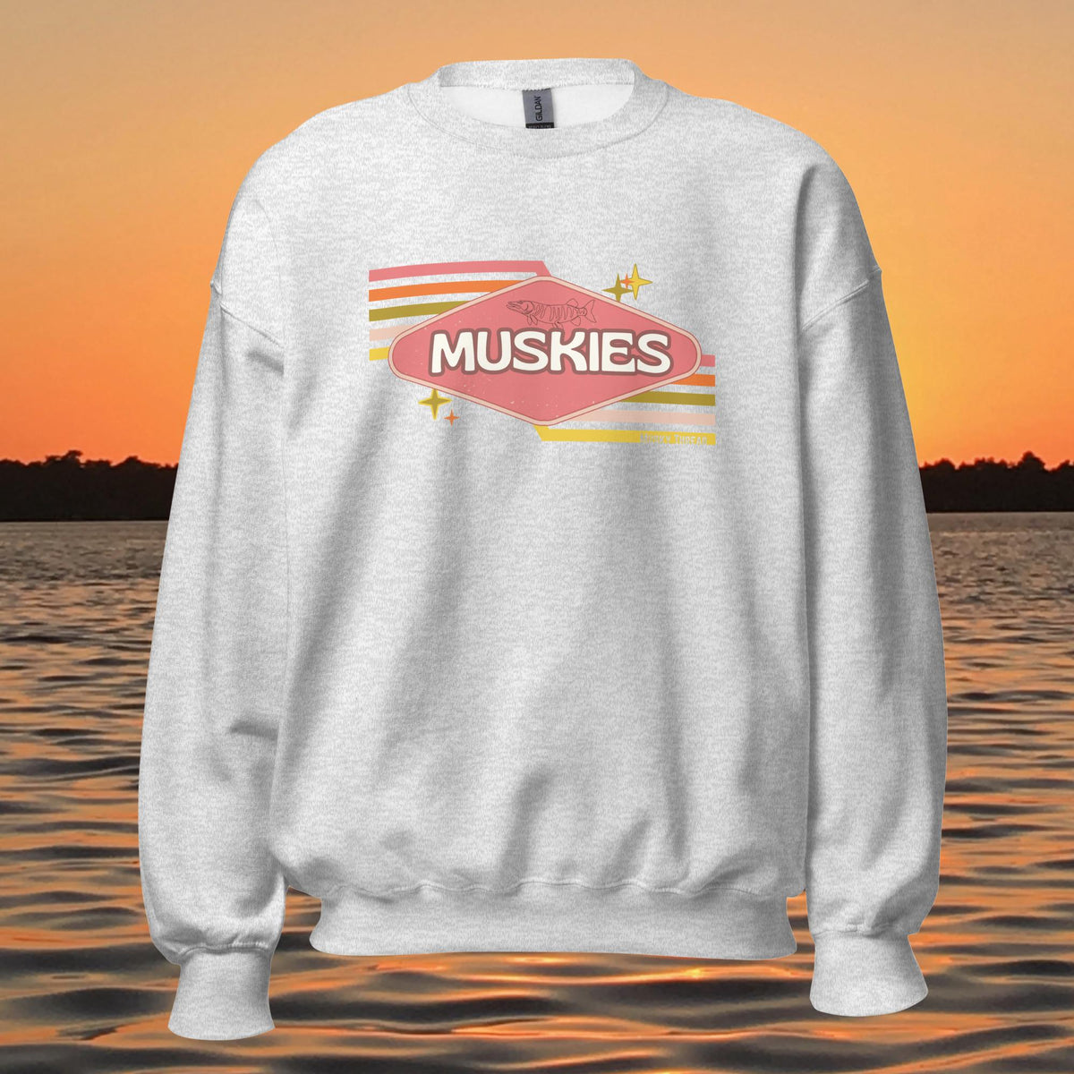 crew neck sweatshirt with Retro Muskie Sign graphic, vintage pink and yellow badge design featuring musky fish, lake sunset background