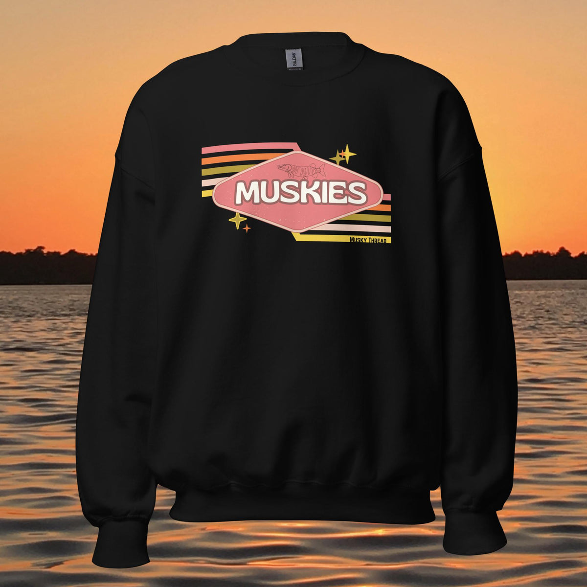 crew neck sweatshirt with Retro Muskie Sign graphic, vintage pink and yellow badge design featuring musky fish, lake sunset background