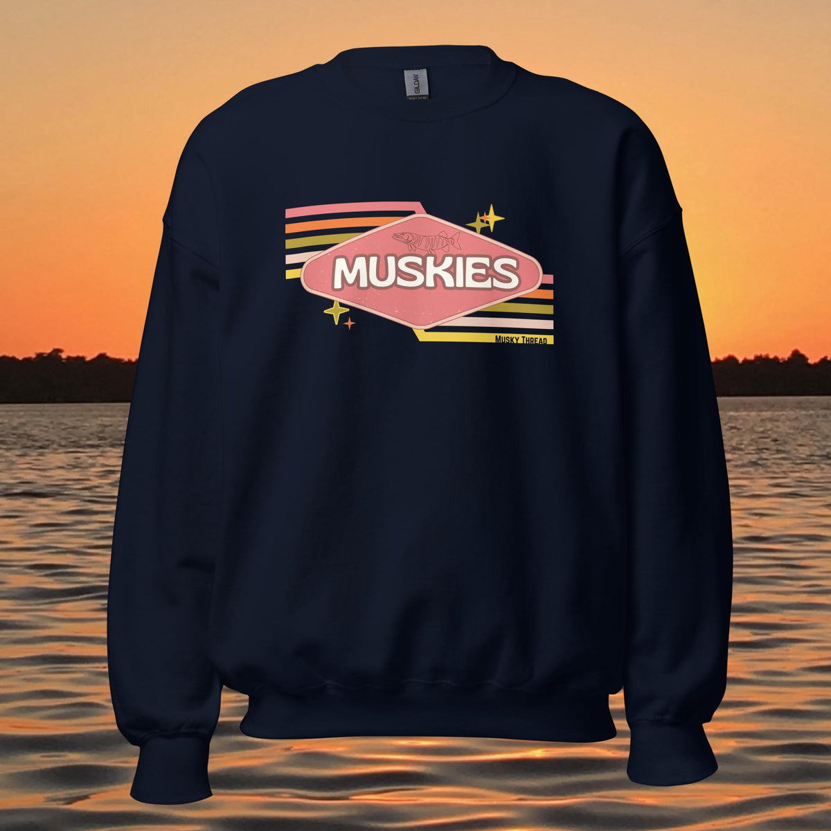 crew neck sweatshirt with Retro Muskie Sign graphic, vintage pink and yellow badge design featuring musky fish, lake sunset background