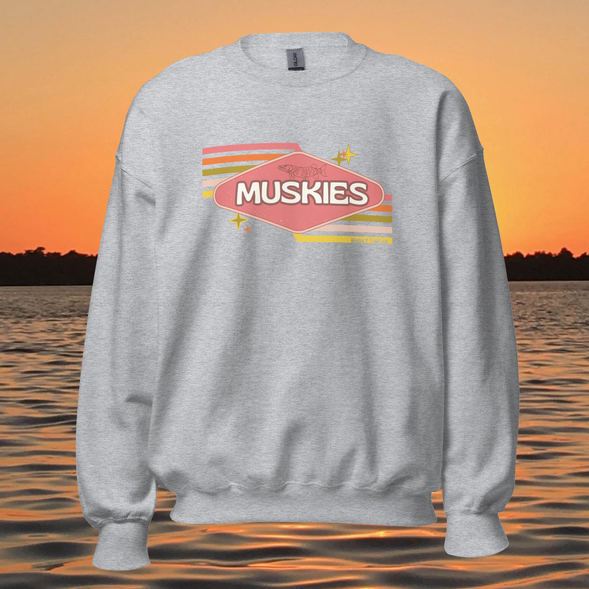 crew neck sweatshirt with Retro Muskie Sign graphic, vintage pink and yellow badge design featuring musky fish, lake sunset background