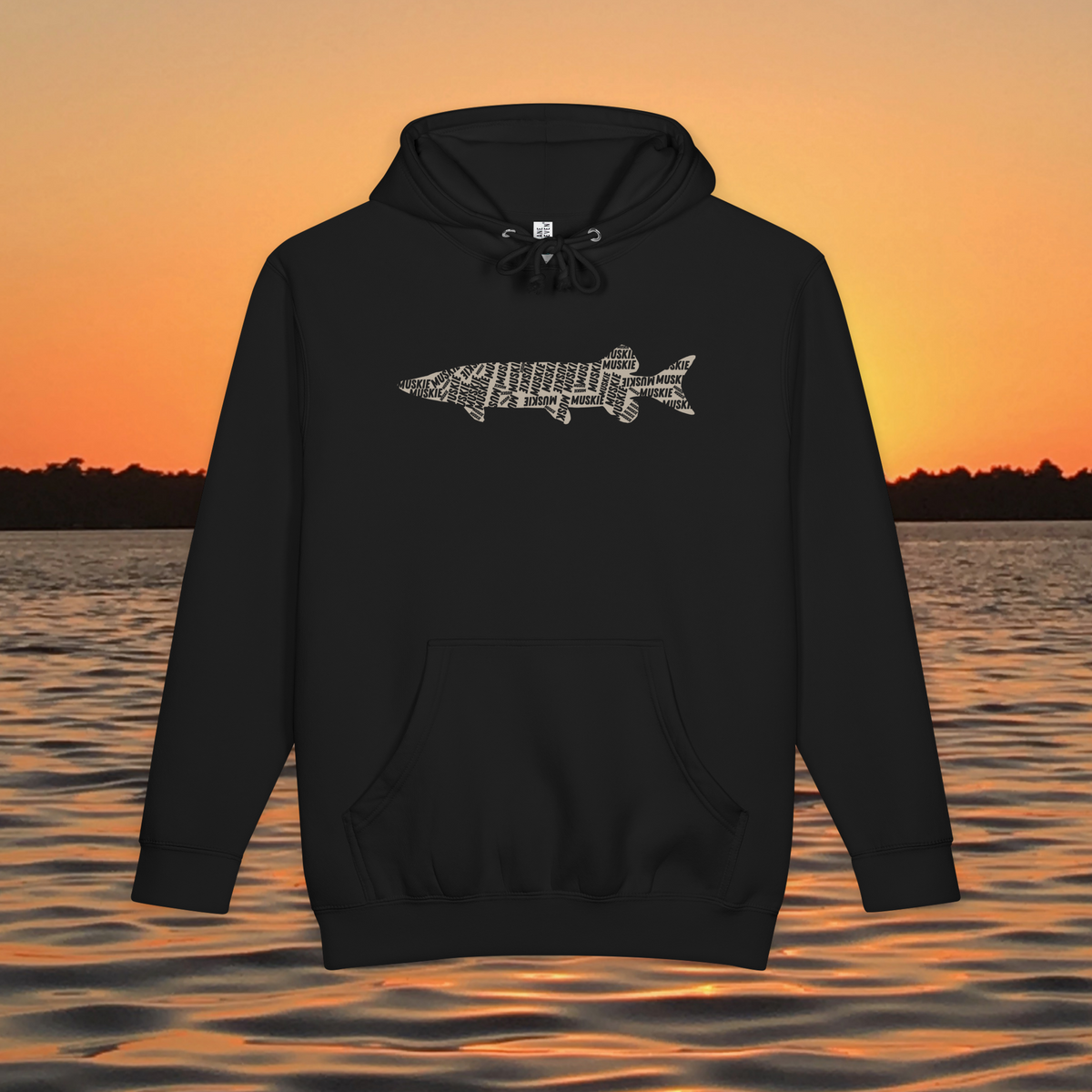 Muskie Lives Within Us black heavyweight hoodie with tan MUSKIE word art fish silhouette over sunset lake