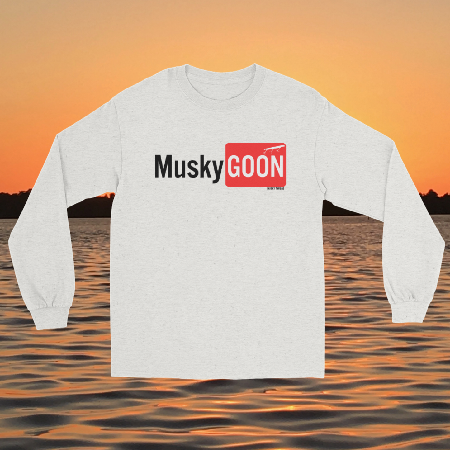 long sleeve shirt with white and red "MuskyGOON" fishing lure graphic, front view on sunset lake background
