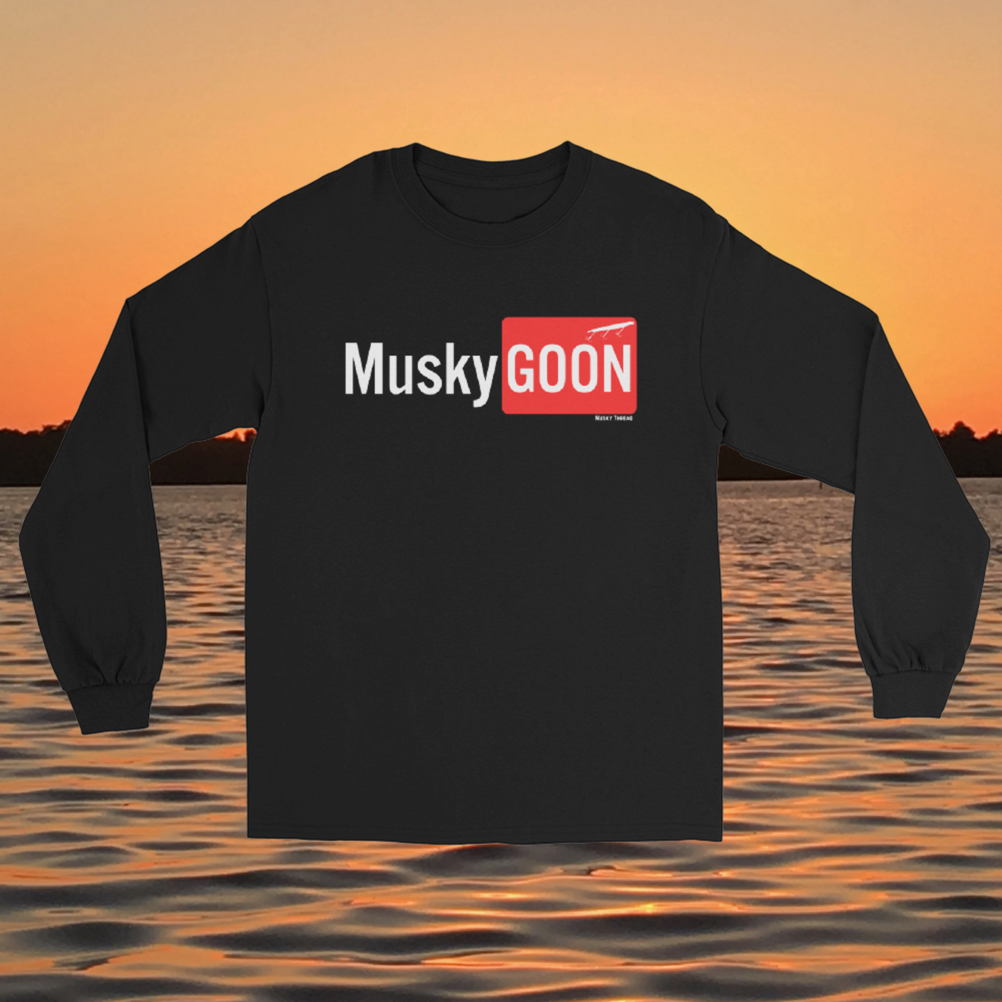 long sleeve shirt with white and red "MuskyGOON" fishing lure graphic, front view on sunset lake background
