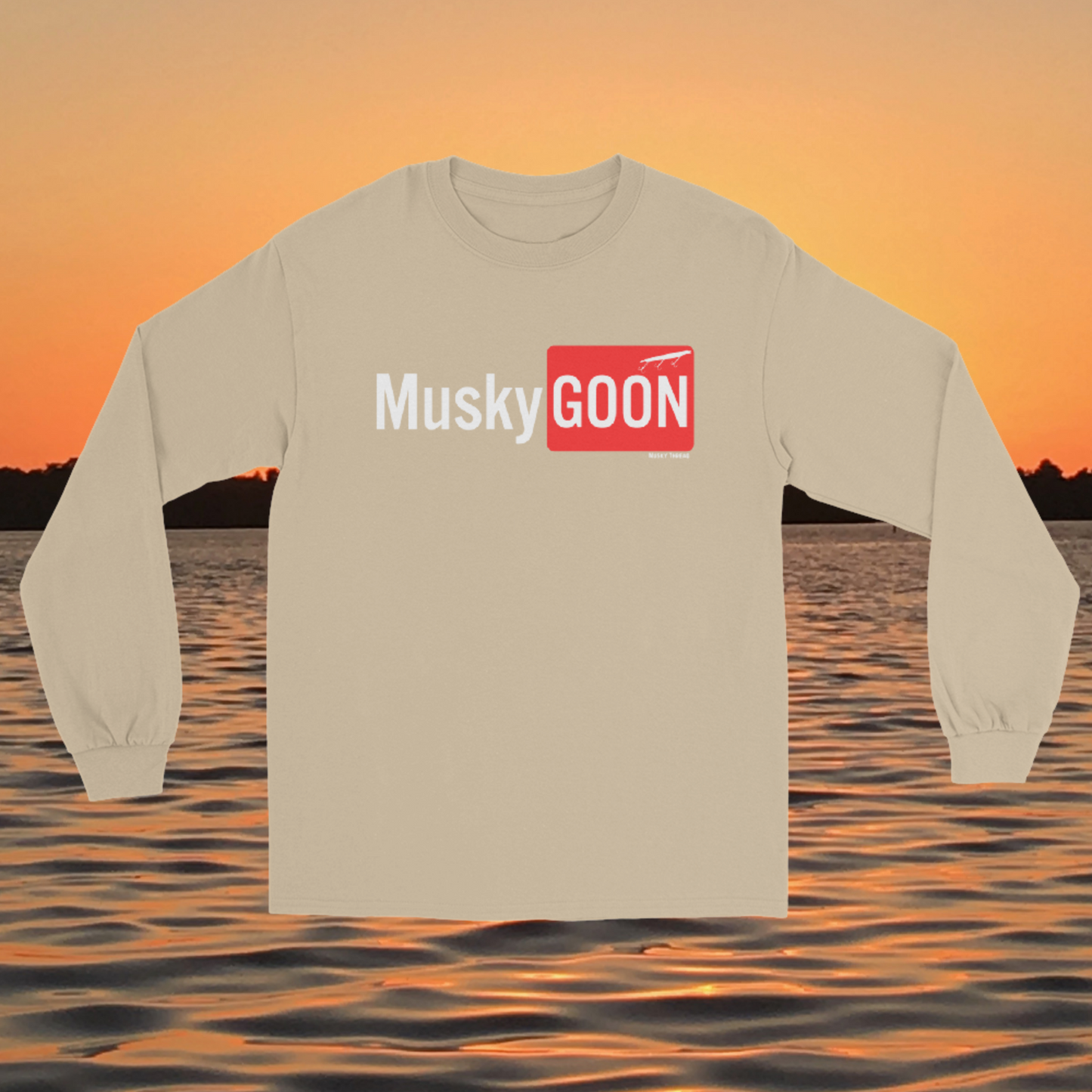 long sleeve shirt with white and red "MuskyGOON" fishing lure graphic, front view on sunset lake background
