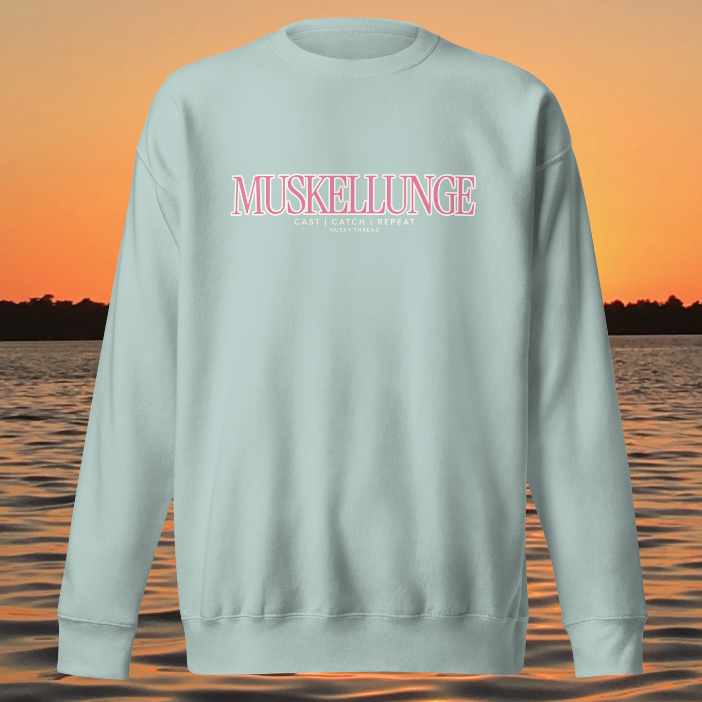 Muskellunge Cast Catch Repeat sweatshirt with pink lettering, lake sunset background