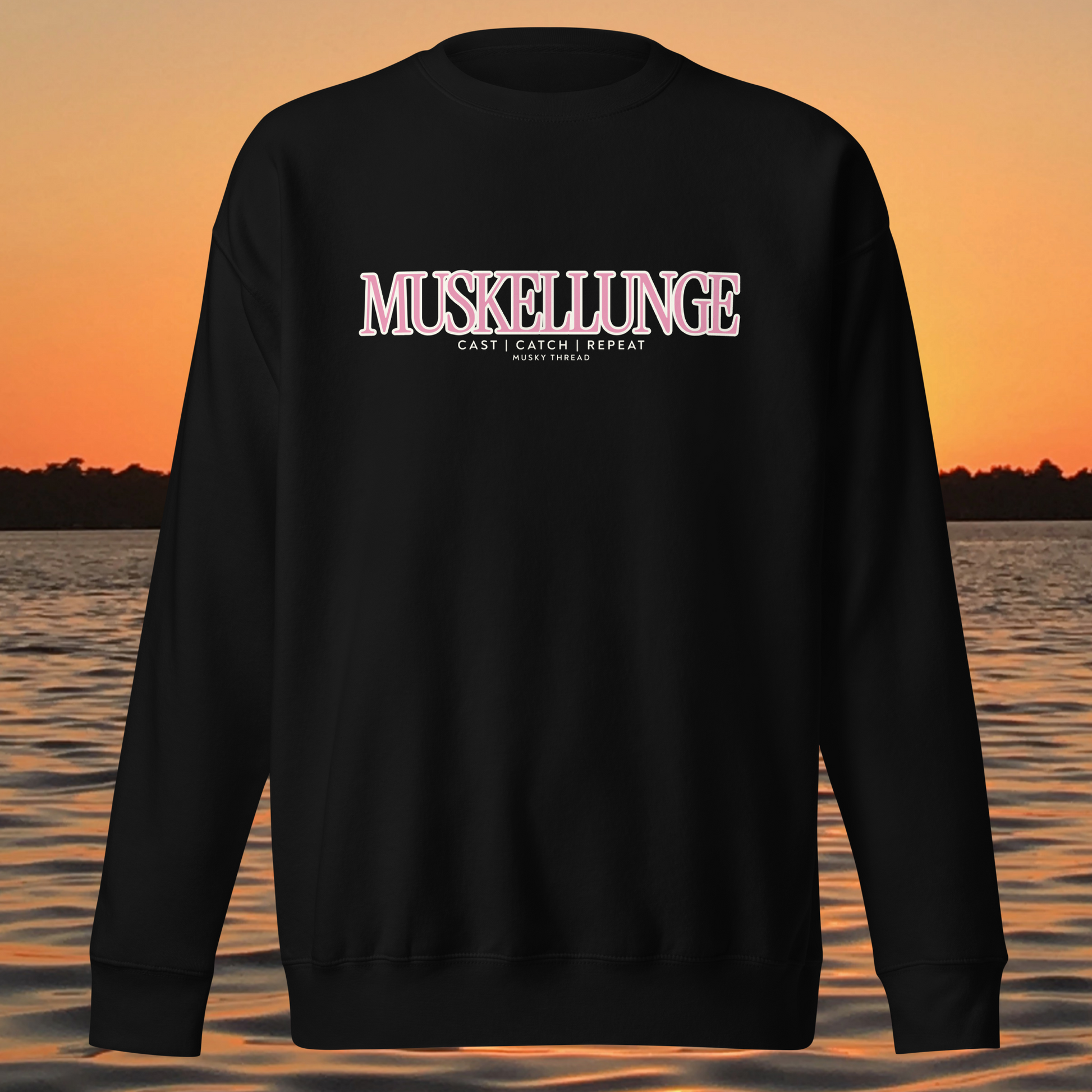 Muskellunge Cast Catch Repeat sweatshirt with pink lettering, lake sunset background