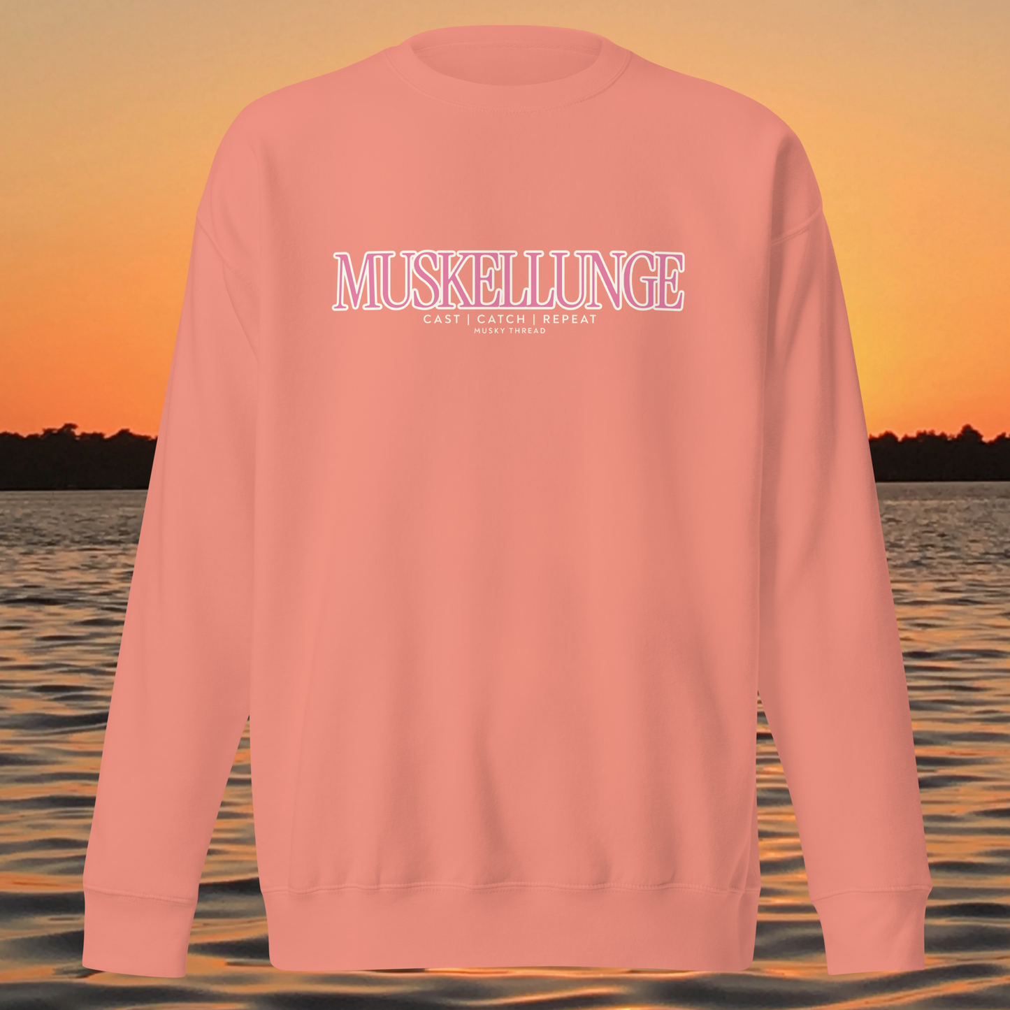 Muskellunge Cast Catch Repeat sweatshirt with pink lettering, lake sunset background