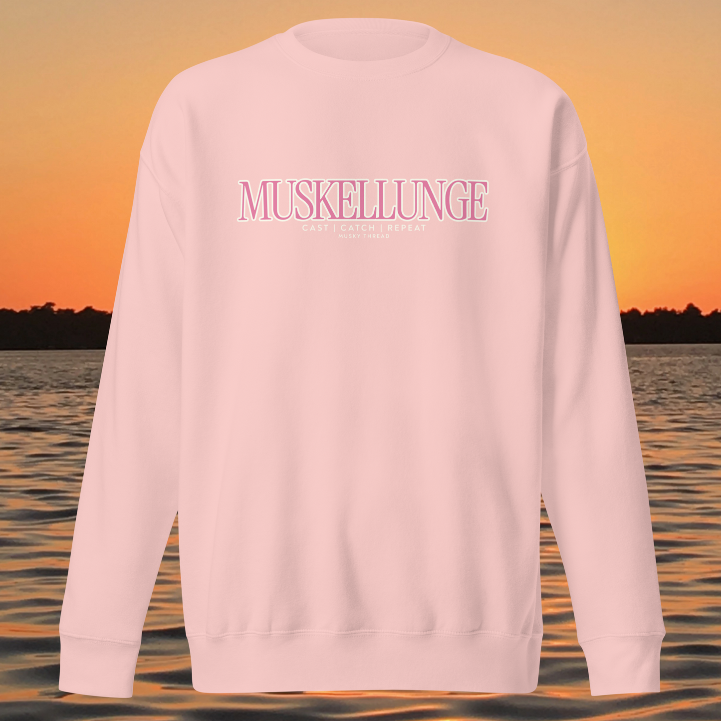 Muskellunge Cast Catch Repeat sweatshirt with pink lettering, lake sunset background
